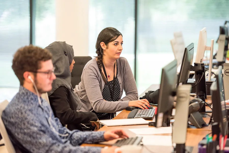 Agents with headsets working through their cases at their desks